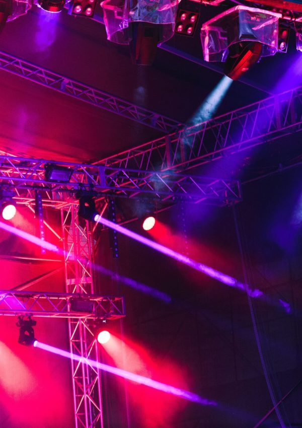 Spotlights, red and blue beams of lights above stage during concert event festival